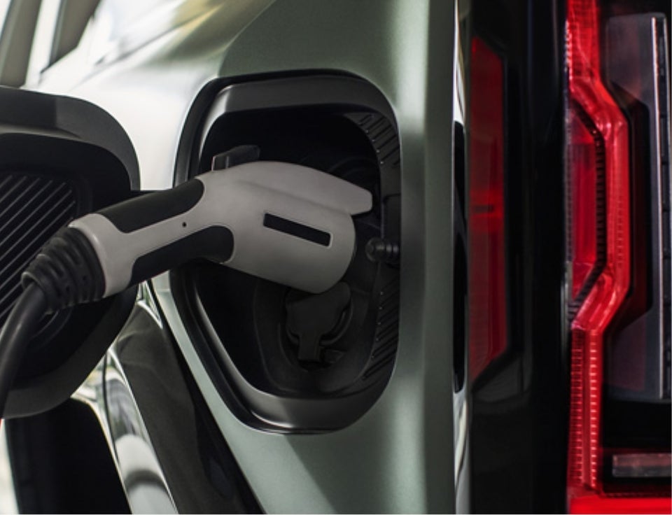 Close up of charging port with charger plugged in on a GMC Hummer EV SUV - Borjon Auto Center in PASO ROBLES CA